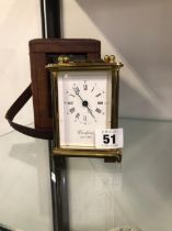 A WOODFORD BRASS CASED CARRIAGE CLOCK AND AN ASSOCIATED OUTER LEATHER TRAVEL CASE.