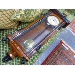 A VICTORIAN WALNUT AND EBONISED WALL CLOCK.