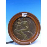 AN ART NOUVEAU BRONZE ROUNDEL CAST IN RELIEF WITH A NUDE LADY AND CHILD BELOW A TREE, INDISTINCTLY