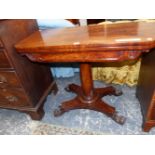 A 19th C. MAHOGANY GAMES TABLE, THE ROUNDED RECTANGULAR TOP SWIVELLING OPEN ON A GUN BARREL
