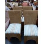 A SET OF FOUR BASKET WEAVED CHAIRS WITH UPHOLSTERED SEATS