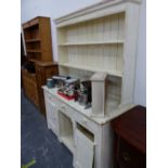 A WHITE PAINTED PINE DRESSER WITH ENCLOSED TWO SHELF BACK, THE BASE WITH AN OPEN SHELF FLANKED BY
