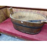 AN ANTIQUE LARGE COOPERED IRON BOUND TUB.