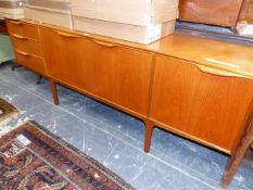 A 20th C. SCANDINAVIAN TASTE TEAK SIDE BOARD, THE CENTRAL CUPBOARD FLANKED BY THREE DRAWERS AND A