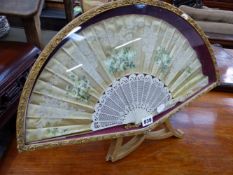 A CASED SILK FAN.