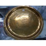 AN ARTS AND CRAFTS BRASS DISH BY PHILIP FREDERICK ALEXANDER WITH CENTRAL CHRISTIAN CYPHER WITHIN