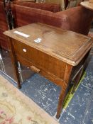 A 20th C. OAK WORK TABLE WITH A TRAY AND A CHINOISERIE TIN BOX INSIDE THE COMPARTMENT ABOVE A DRAWER