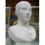 A PLASTER CLASSICAL BUST OF A MAN WEARING A HEAD BAND. H 38cms.