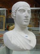 A PLASTER CLASSICAL BUST OF A MAN WEARING A HEAD BAND. H 38cms.