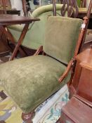 A VICTORIAN WALNUT NURSING CHAIR, THE OLIVE GREEN VELVET UPHOLSTERED RECTANGULAR BACK BETWEEN FLUTED