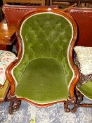 A VICTORIAN MAHOGANY SHOW FRAME ARMCHAIR BUTTON BACKED IN GREEN VELVET, A STOOL EN SUITE TOGETHER