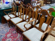 A SET OF EIGHT 20th C. WALNUT CHAIRS, TO INCLUDE TWO WITH ARMS, THE ARCHED TOP RAILS CENTRED BY A