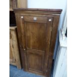 A VICTORIAN PINE CUPBOARD WITH A TWO PANELLED DOOR ENCLOSING SHELVES. W 61 x D 47 x H 124cms.