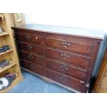 A GEORGIAN OAK BLANKET CHEST OF FOUR DRAWERS BETWEEN QUARTER ROUND REEDED PILASTERS ABOVE BRACKET