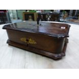 A GERMAN VINTAGE POLYPHON IN A STAINED WOOD CASE AND PLAYING 18cms. METAL DISCS, THE CASE. W 44 x D