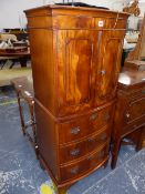 A MODERN MAHOGANY BOW FRONT CABINET WITH A CUPBOARD OVER THREE DRAWERS AND BRACKET FEET. W 55 x D 41