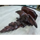 A VICTORIAN MAHOGANY WALL SHELF SUPPORTED ON THE BACK OF A SPREAD EAGLE ON A BRANCH ABOVE