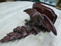 A VICTORIAN MAHOGANY WALL SHELF SUPPORTED ON THE BACK OF A SPREAD EAGLE ON A BRANCH ABOVE