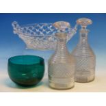 A PAIR OF GEORGE III CUT GLASS HALF BOTTLE DECANTERS AND STOPPERS, A TWO HANDLED TRAILED GLASS BOWL.