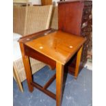 A CHILDS DESK WITH INKWELL RECIEVERS IN FRONT OF THE LID SLOPING ABOVE THE TAPERING SQUARE SECTIONED