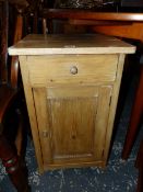 A PINE BEDSIDE CUPBOARD WITH A DRAWER OVER A DOOR. H 64.5cms.