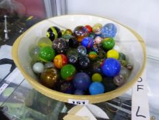 A LARGE BOWL OF DECORATIVE MARBLES.