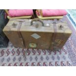 A LARGE VINTAGE LEATHER SUITCASE.