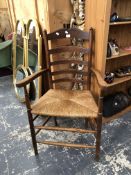 A COUNTRY MADE LADDER BACK RUSH SEAT ARMCHAIR