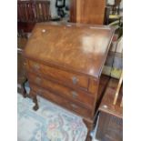 A 20th C. MAHOGANY BUREAU, THE FALL ABOVE THREE DRAWERS AND CABRIOLE LEGS ON BALL AND CLAW FEET. W