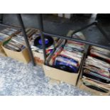 A LARGE COLLECTION OF VINTAGE 7" RECORD SINGLES.