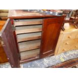 A 19th C. STAINED PINE PRESS, THE MAHOGANY DOORS OPENING ONTO FIVE SLIDES. W 97 x D 46.5 x H