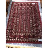 AN ORIENTAL RUG OF PERSIAN DESIGN. 186 x 122cms. TOGETHER WITH A MACHINE MADE RUG OF TURKOMAN