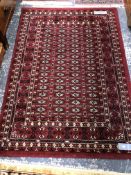 AN ORIENTAL RUG OF PERSIAN DESIGN. 186 x 122cms. TOGETHER WITH A MACHINE MADE RUG OF TURKOMAN