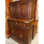 A 19th C. OAK CABINET, THE DOORS TO THE RECESSED TOP AND TO THE BASE WITH PRINTS OF DUTCH CHILDREN.