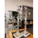 A PAIR OF SILVER PLATED CANDELABRA.