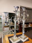 A PAIR OF SILVER PLATED CANDELABRA.