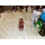 A QUANTITY OF CUT GLASS VASES, DECANTERS, DRINKING GLASS WARES ETC.
