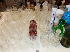 A QUANTITY OF CUT GLASS VASES, DECANTERS, DRINKING GLASS WARES ETC.