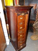 AN OAK OFFICE CABINET WITH ROLL UP SLATTED DOOR OVER EIGHT DRAWERS AND PLINTH FOOT. W 37 x D 50