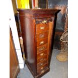 AN OAK OFFICE CABINET WITH ROLL UP SLATTED DOOR OVER EIGHT DRAWERS AND PLINTH FOOT. W 37 x D 50