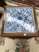 A CHINESE BLUE AND WHITE PORCELAIN INSET TWO TIER TABLE, THE APRON CARVED WITH BATS, THE SQUARE LEGS