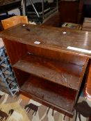 A 19th C. MAHOGANY COMMODE STOOL. W 54 x D 41.5 x H 46cms. TOGETHER WITH AN OPEN BOOK CASE. W 68 x H