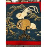 A JAPANESE BLUE GROUND SILK WORK PANEL SEWN WITH A WHITE HEN AND CHICKS AND A COCKEREL PERCHED ON