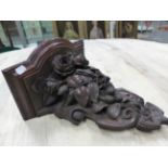 A VICTORIAN PIERCED AND CARVED OAK WALL BRACKET, THE SHELF ABOVE A SCROLLING SHIELD SHAPE WITH ROSES