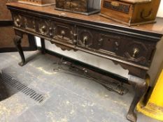 A 19th C. OAK DRESSER BASE WITH THREE GEOMETRICALLY PANELLED DRAWERS OVER CABRIOLE LEGS ON TREFID