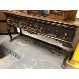 A 19th C. OAK DRESSER BASE WITH THREE GEOMETRICALLY PANELLED DRAWERS OVER CABRIOLE LEGS ON TREFID