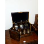 A 19th C. COROMANDEL THREE DECANTER BOX, THE RECTANGULAR LID OPENING TO ALLOW FRONT DOORS TO OPEN, E