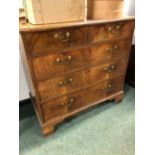 A GEORGE III WALNUT CHEST OF DRAWERS, THE TOP QUARTER VENEERED WITHIN CROSS BANDING ABOVE TWO