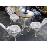 A SET OF FOUR WHITE PAINTED CAST IRON GARDEN CHAIRS WITH PIERCED CIRCULAR SEATS AND FOLIATE BACKS,