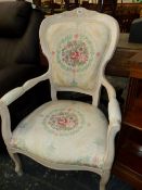 A CREAM PAINTED SHOW FRAME ARMCHAIR, THE UPHOLSTERY WITH WREATHED FLORAL ROUNDELS